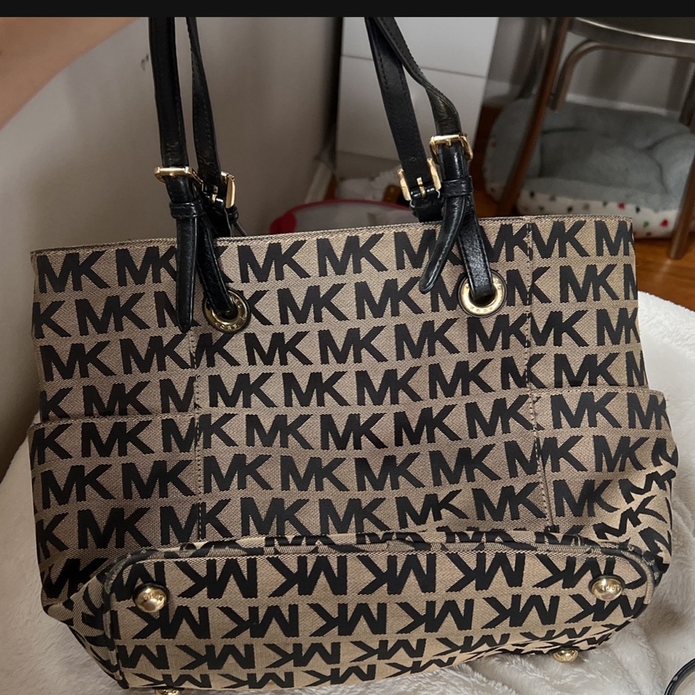 A Brown Michael Kors Purse With The MK logo In Black